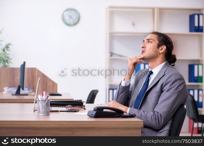 The unhappy male businessman in the office. Unhappy male businessman in the office