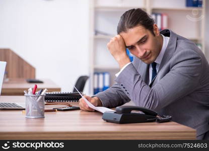 The unhappy male businessman in the office. Unhappy male businessman in the office