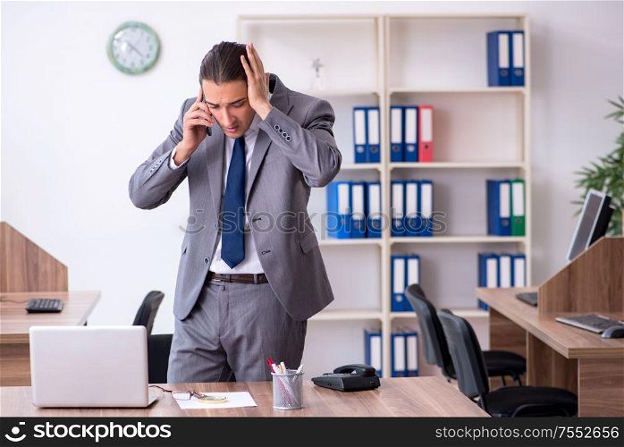 The unhappy male businessman in the office. Unhappy male businessman in the office