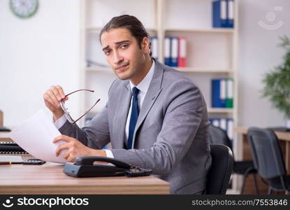 The unhappy male businessman in the office. Unhappy male businessman in the office