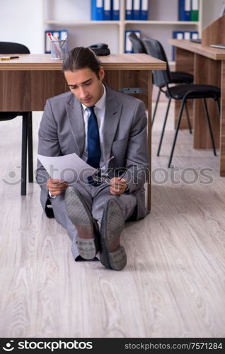 The unhappy male businessman in the office. Unhappy male businessman in the office