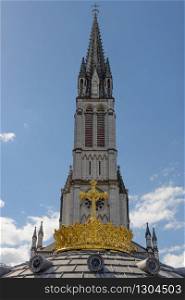 The Upper Basilica with gilded crown ad cross in Lourdes, France