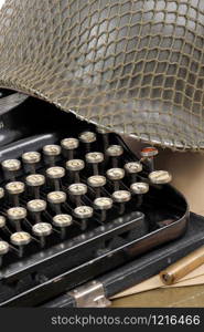 the US military helmet of the Second World War with old typewriter