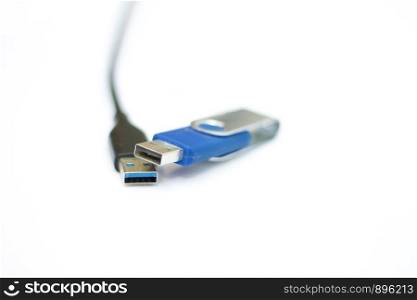 The USB cable and usb flash memory isolated on the white background
