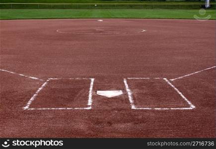 The view from behind the plate on a vacant softball field.. Behind the Plate