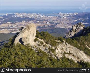 The view from the peak to beautiful mountains ans Sokcho city. Seoraksan National Park. South Korea
