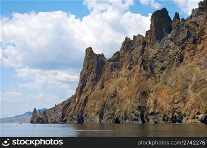 The view on Karadag rock (reserve on place of ancient extinct volcano) from the side of a excursion ship (Crimea, Ukraine)