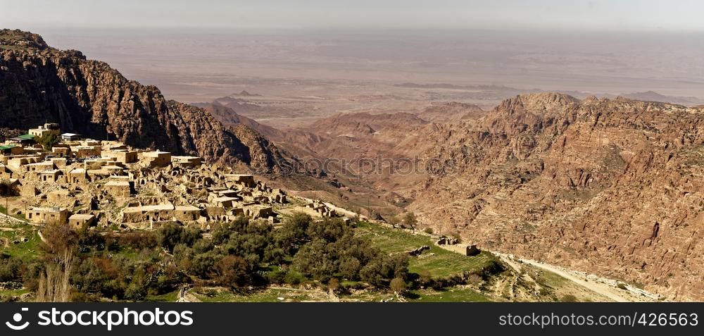 The village of Dana on the edge of the Dana Reserve, a deep valley cut in the south-western mountainous region of the Kingdom of Jordan, panoramic view, middle east