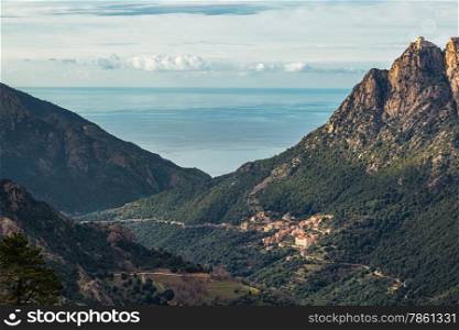The village of Ota in Corsica with mountains and the Mediterranean sea behind