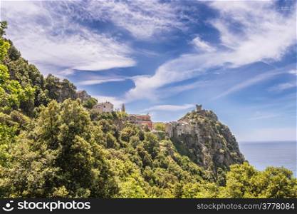 The Village, tower and church of Nonza on Cap Corse in Corsica against a dramatic blue sky