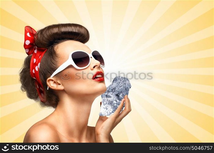 The vintage photo of a glamorous vintage pin-up girl holding a cool ice cube on her skin for rejuvenation on colorful abstract cartoon style background.