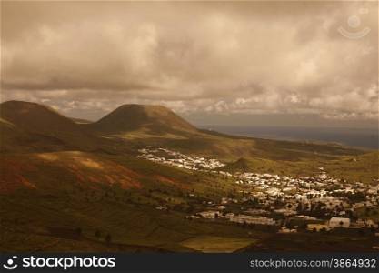 The volcanic Hills near the Village of Haria on the Island of Lanzarote on the Canary Islands of Spain in the Atlantic Ocean.&#xA;
