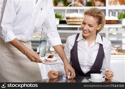 The waiter brings to the visitor the ordered dessert