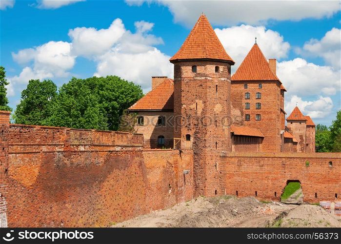 The wall and towers in lower park of the castle of Malbork in early spring. Poland
