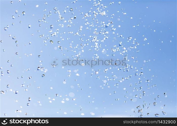 The water drops in the air against the sky. Water drops in the air against the sky