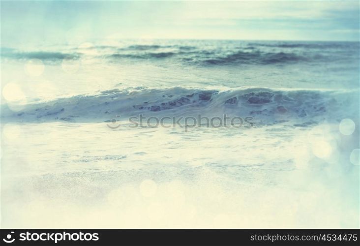 The wave on the beach. Blur background and sunny light. Peaceful nature background.