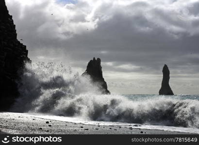 The waves of the Atlantic Ocean hitting the basalt and vulcanic beaches of Iceland&rsquo;s south coast at Reynir, famous for it&rsquo;s troll-like landmasses, erecting out from the ocean
