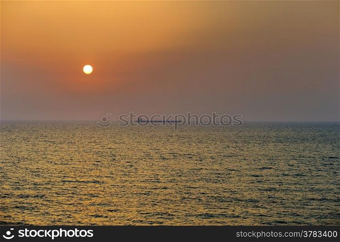 The waves of the Mediterranean Sea in the setting sun