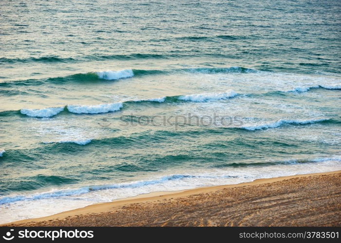 The waves of the Mediterranean Sea in the setting sun