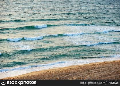 The waves of the Mediterranean Sea in the setting sun