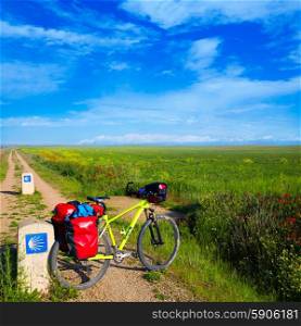 The way of saint James biking with shell sign in cereal fields at Palencia Spain