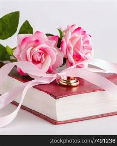 The wedding concept with rings and roses. Wedding concept with rings and roses