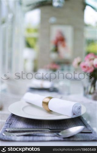The wedding decor. Tables set for an event party or wedding reception. luxury elegant table setting dinner in a restaurant. glasses and dishes. hall for banquets and weddings