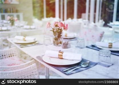 The wedding decor. Tables set for an event party or wedding reception. luxury elegant table setting dinner in a restaurant. glasses and dishes. hall for banquets and weddings