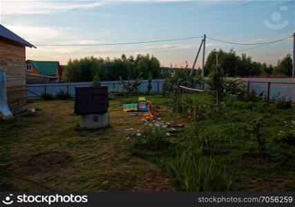 the well in the yard of the house in the evening. the well in the yard of the house in the evening, Russia