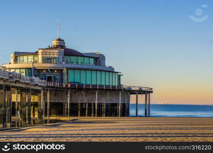 the well known pier jetty of Blankenberge, belgium, touristic holiday spot, belgian beach with beautiful and colorful sky