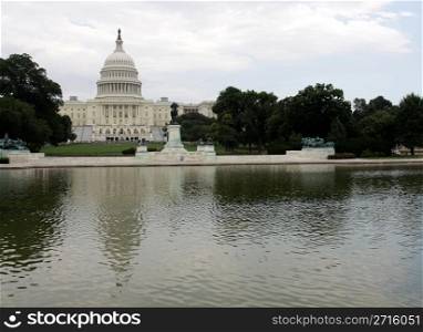 The west side of the United States Capitol building reflected in a pool.. Capitol Hill and Reflection