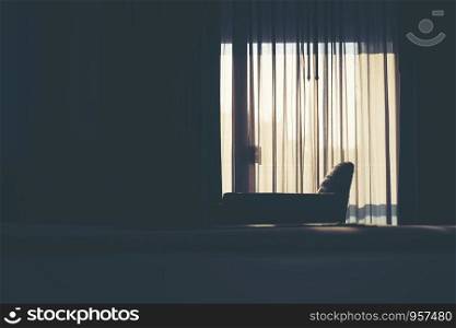 The white curtain separates the sunlight that shines into the bedroom.