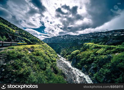 The White Pass and Yukon Route on train passing through vast lan. The White Pass and Yukon Route on train passing through vast landscape. The White Pass and Yukon Route on train passing through vast landscape