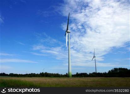The wind generator on a background of the nature and the sky