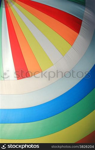 The wind has filled the spinnaker on sailing yacht. Detail of a colorful sail as background.