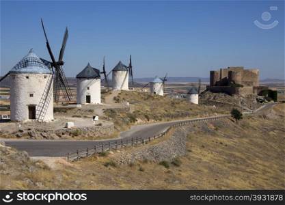 The windmills and castle of Consuegra in the La Mancha region of central Spain.