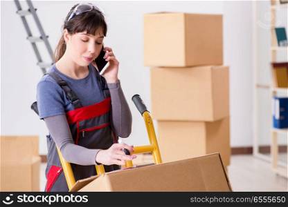 The woman contractor moving boxes in relocation concept. Woman contractor moving boxes in relocation concept
