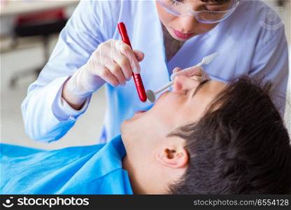 The woman dentist doctor with male patient in hospital. Woman dentist doctor with male patient in hospital