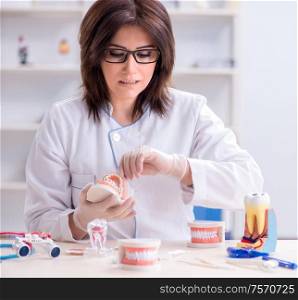 The woman dentist working on teeth implant. Woman dentist working on teeth implant