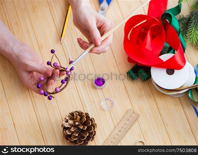 The woman doiing diy festive decorations at home. Woman doiing DIY festive decorations at home