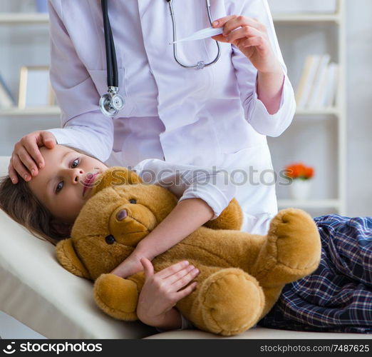 The woman female doctor examining little cute girl with toy bear. Woman female doctor examining little cute girl with toy bear
