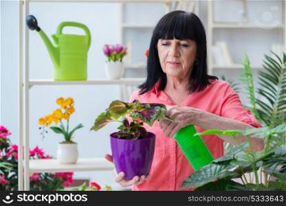 The woman florist working in the flower shop. Woman florist working in the flower shop