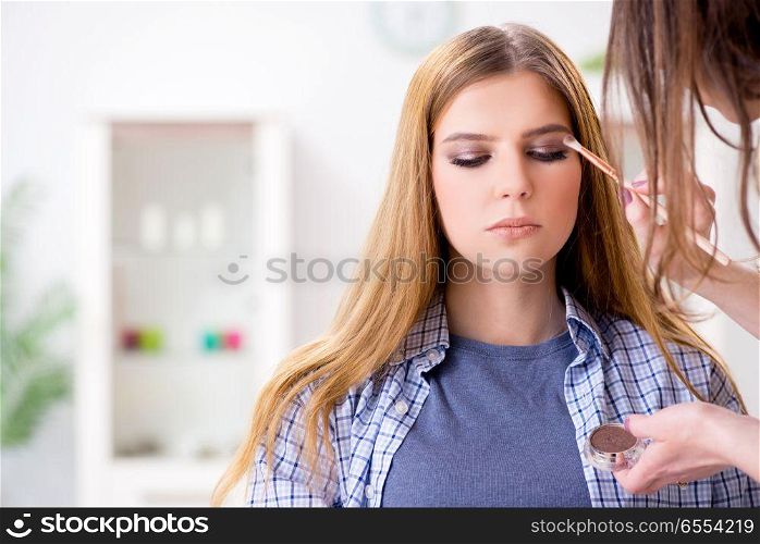 The woman getting her make-up done in beauty salon. Woman getting her make-up done in beauty salon. The woman getting her make-up done in beauty salon