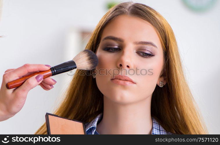 The woman getting her make-up done in beauty salon. Woman getting her make-up done in beauty salon