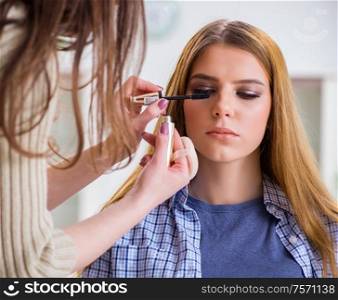 The woman getting her make-up done in beauty salon. Woman getting her make-up done in beauty salon