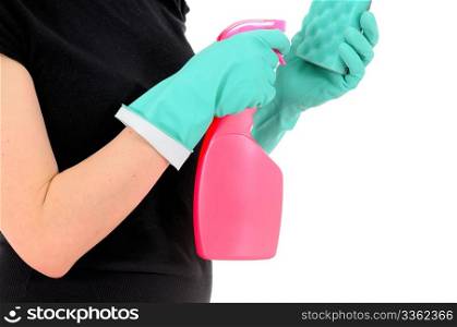 The woman in green gloves pours a washing-up liquid on a sponge
