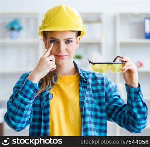 The woman in workshop with protective goggles. Woman in workshop with protective goggles