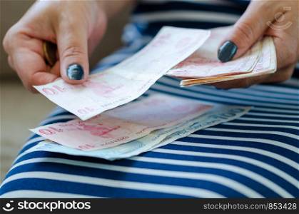 The woman is counting turkish liras