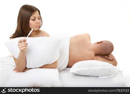 The woman looks at the sleeping man not knowing about its pregnancy