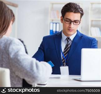 The woman makes payment with credit card. Woman makes payment with credit card